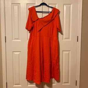 Coral colored asymmetrical neck line.